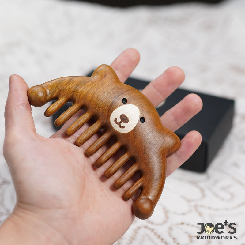 Cute bear-shaped wooden massage comb held in hand – Joe&