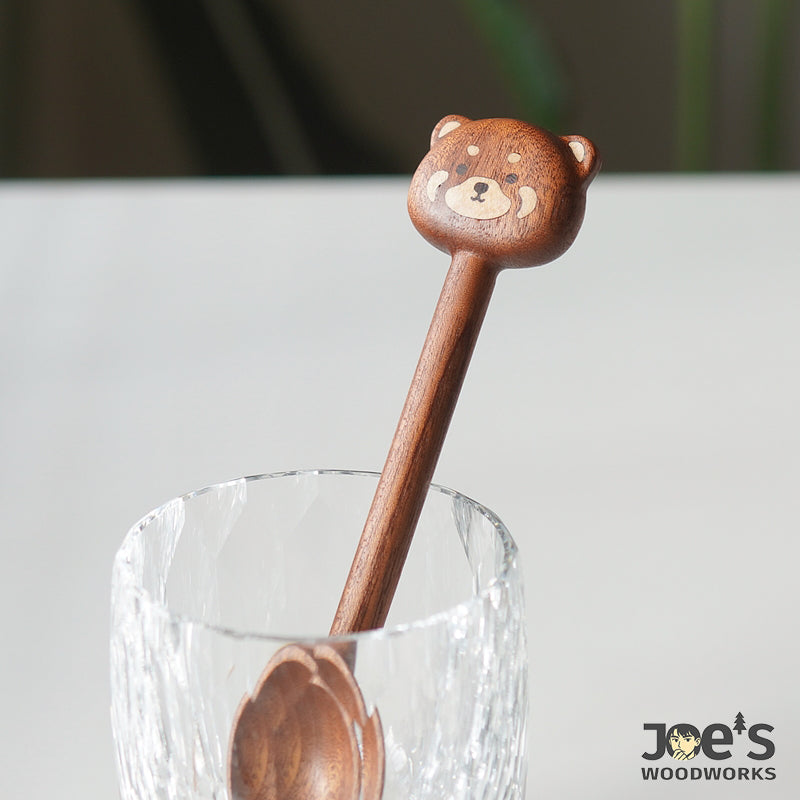 Cute bear head scoop standing in a glass, perfect for home decor or daily kitchen use.