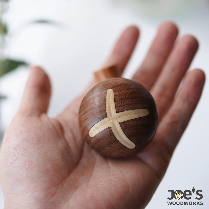 Hand holding a realistic blooming shiitake mushroom fridge magnet made of walnut wood