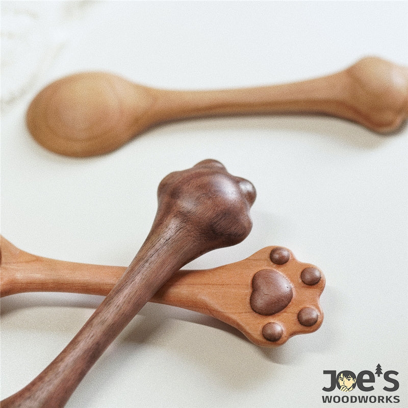 Close-up of the cat paw-shaped spoon handles showing the back view