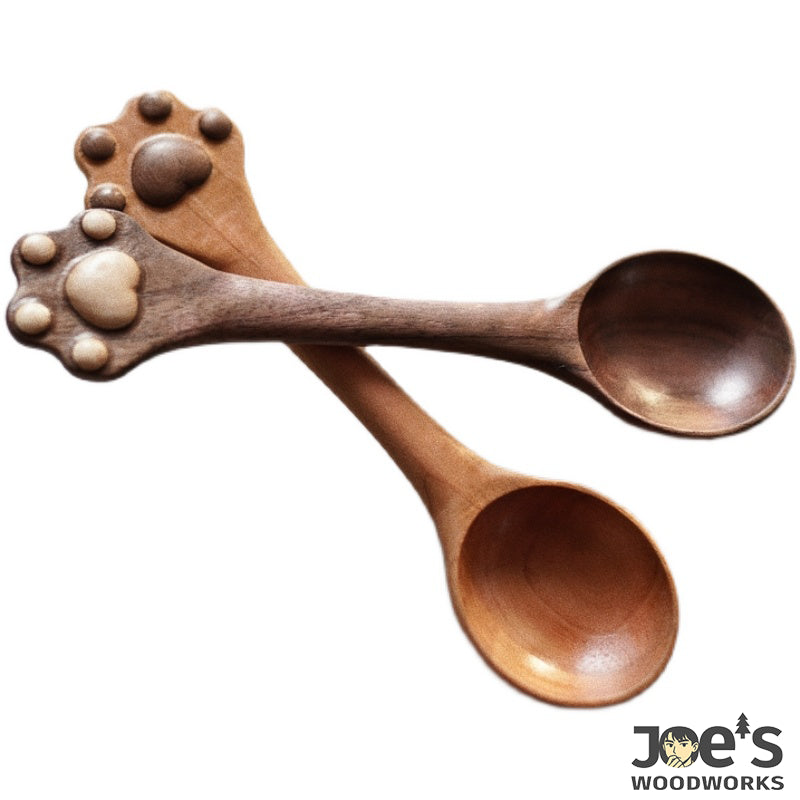 Pair of cat paw wooden spoons with clear view on white background