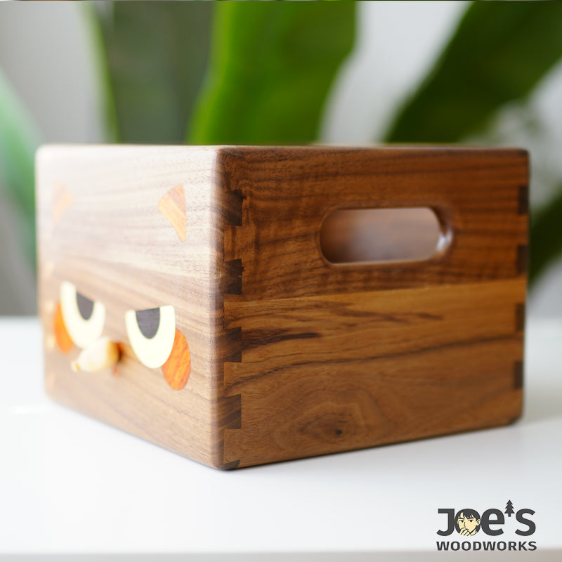 Side detail of walnut cat tissue box showing dovetail joints