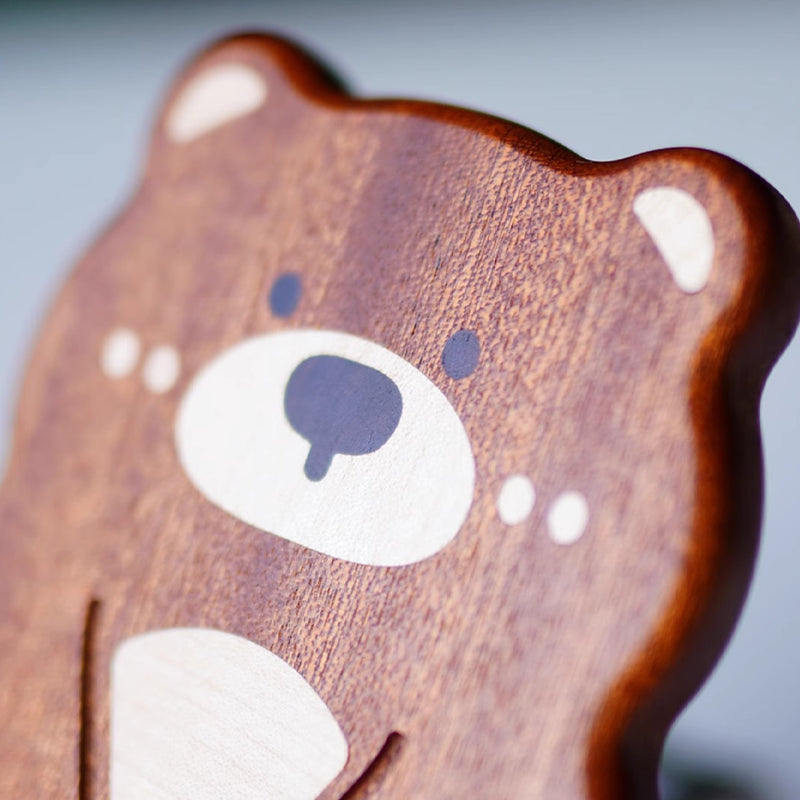 Closeup of cute bear face on wooden phone stand