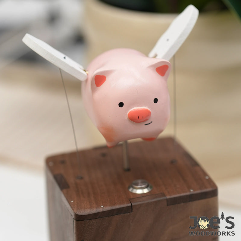 Close-up of the handcrafted pig automaton with white wings