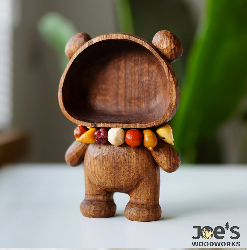 Wooden fruit bead bracelet displayed with bear-shaped wood bowl