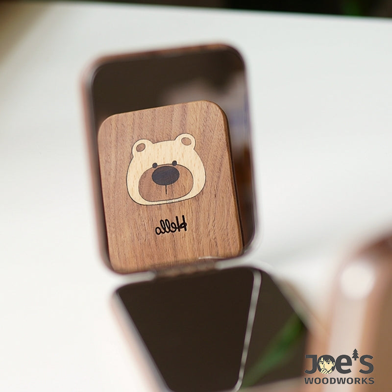Close-up of Lumi Bear mirror’s carved Hello message and wood texture