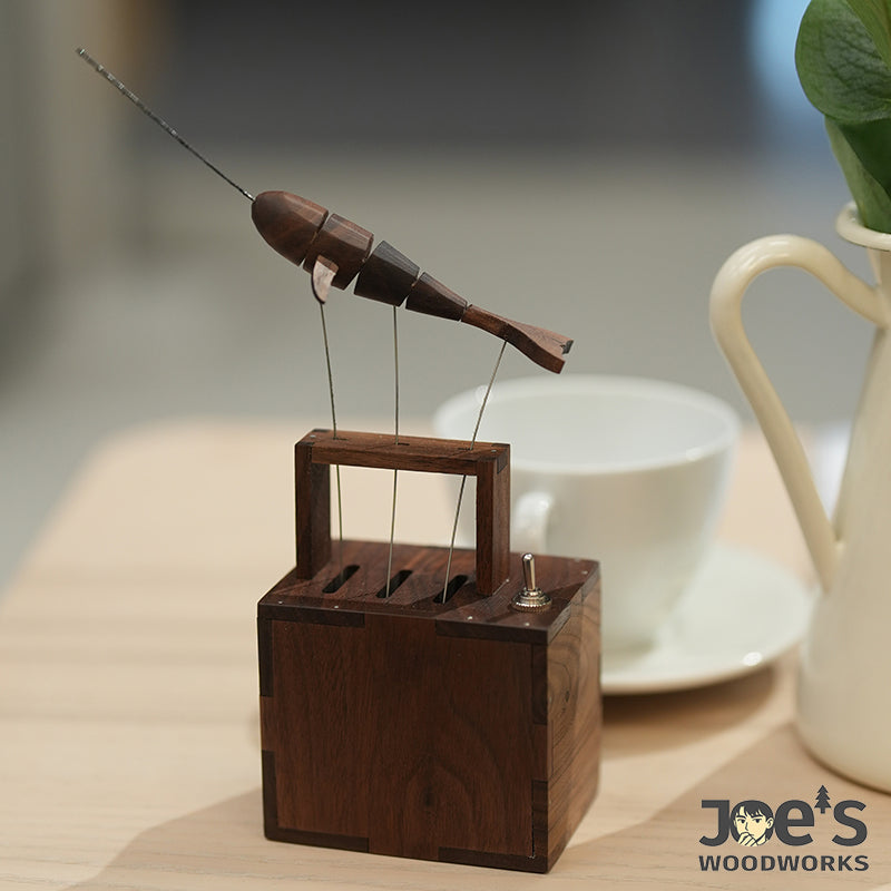 Whale automaton near cup on café table – Joe’s Woodworks style