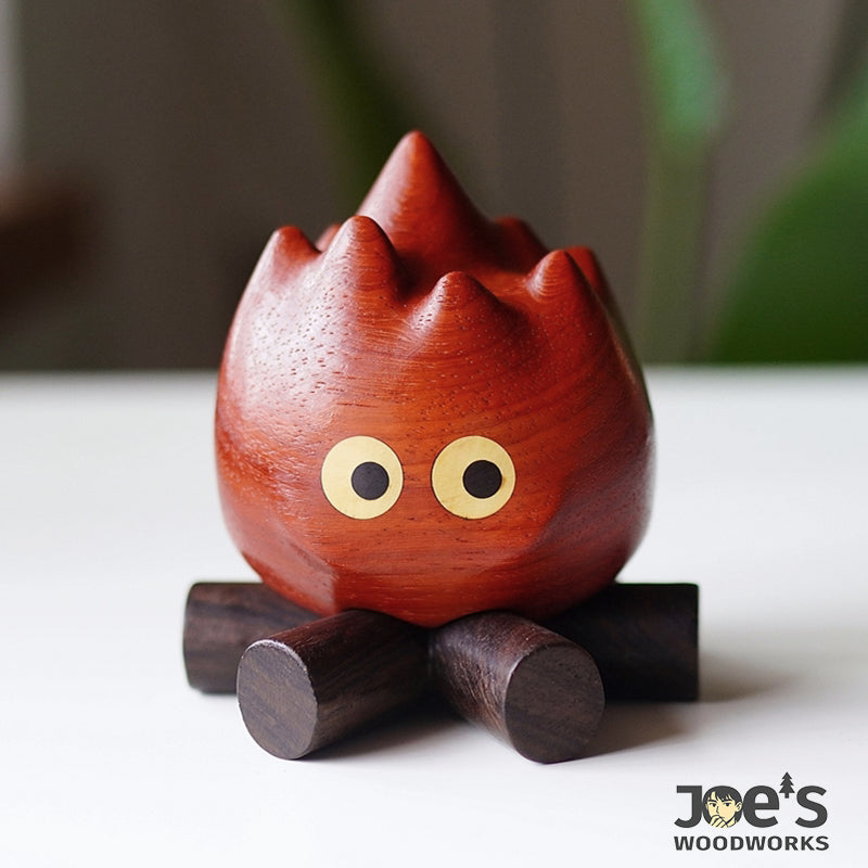 Front view of the fire flame figurine resting on its wooden base