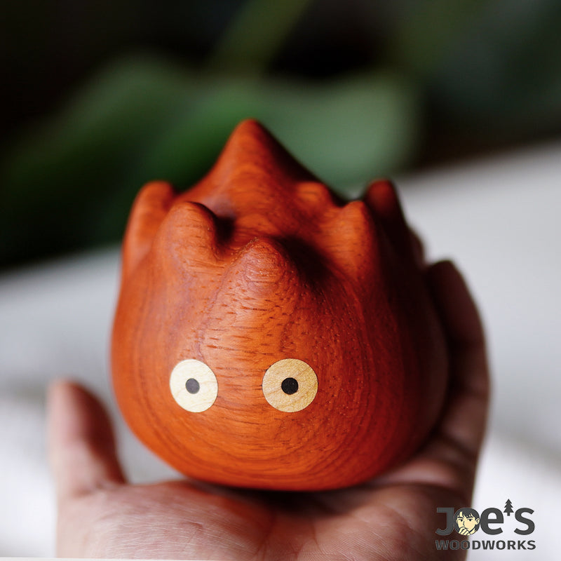 The figurine placed in a hand to show its compact, palm-sized scale