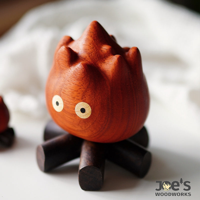 Side perspective of the wooden fire flame figurine highlighting its sculpted curves