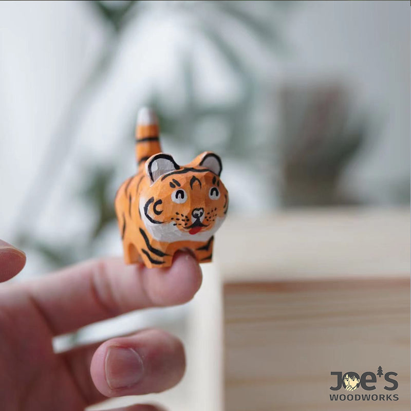 Mini tiger figurine carved from walnut wood, small enough to hold in one hand