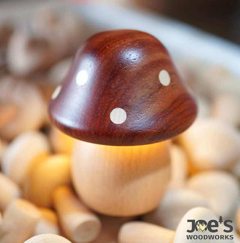 Close-up of glowing wooden mushroom night lamp in handmade workshop