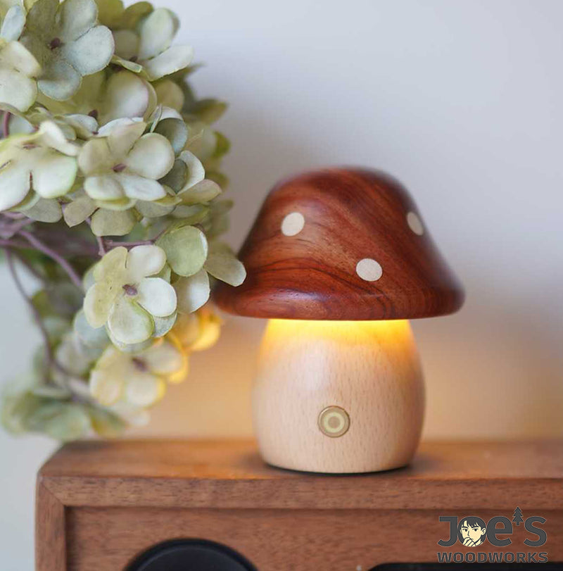 Wooden mushroom night light glowing softly on speaker next to flowers