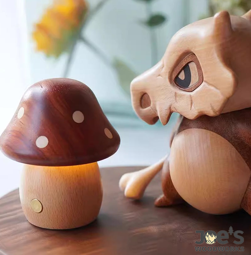 Mini mushroom night light next to carved wooden animal figure