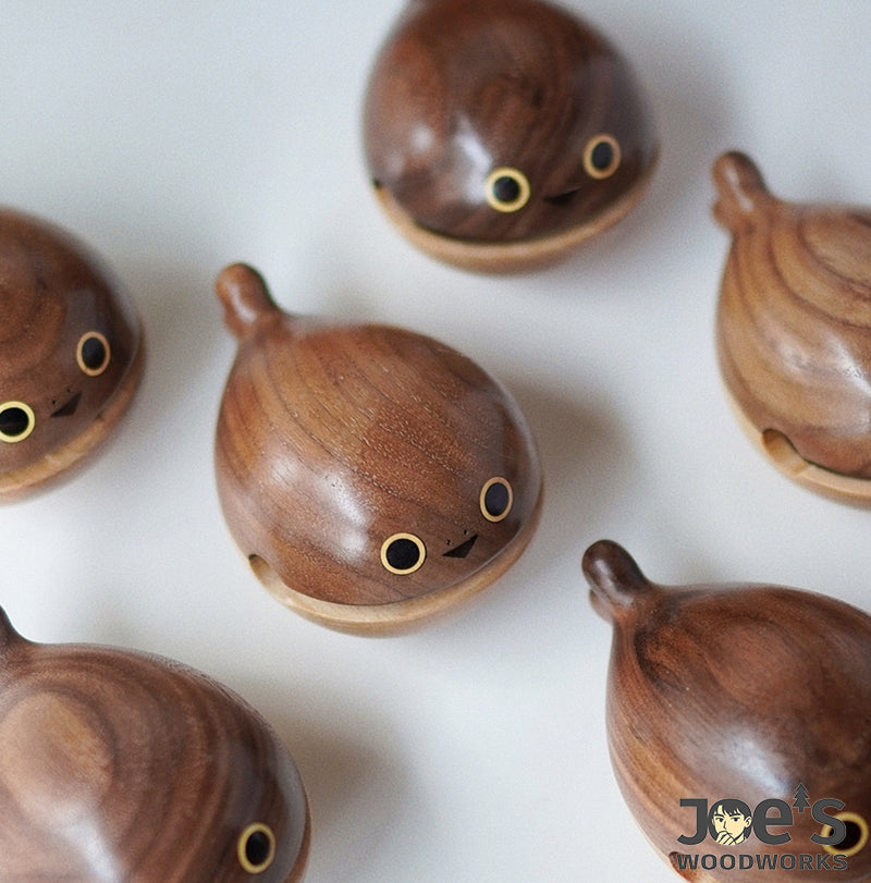 Multiple Mini Whale Knock Toys made of walnut wood – handcrafted in playful cartoon style