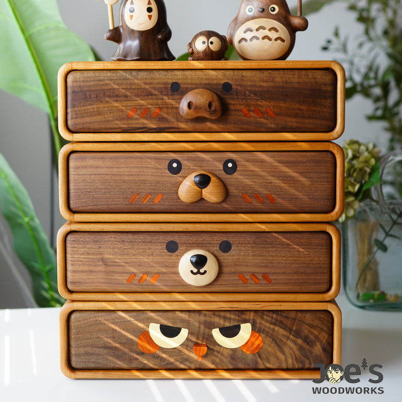 Detailed view of multiple drawers with different animal faces in wood cabinet