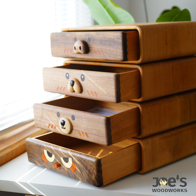 Mini wooden drawer cabinet showing side view with drawers partially opened