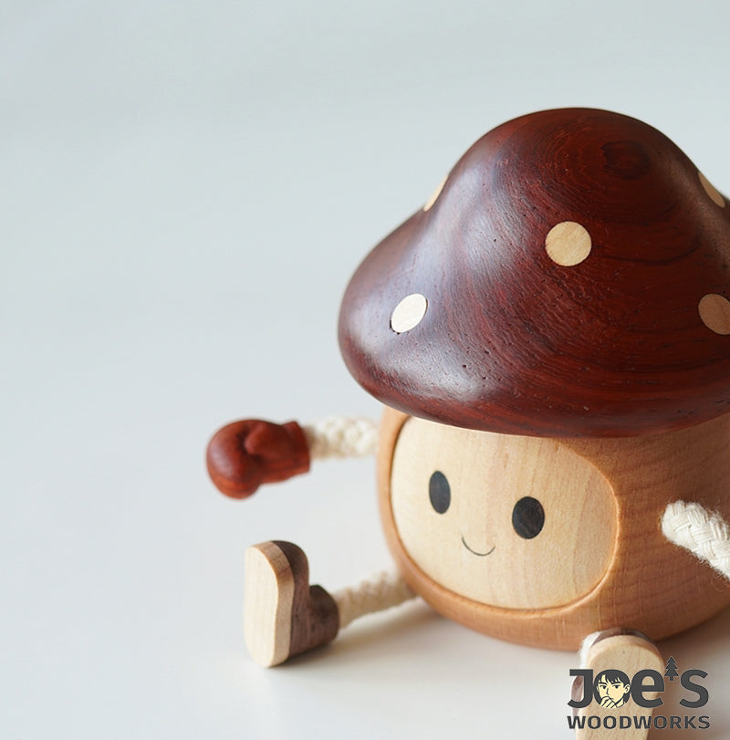 Close-up of mushroom wooden doll with smiling face and polished red top