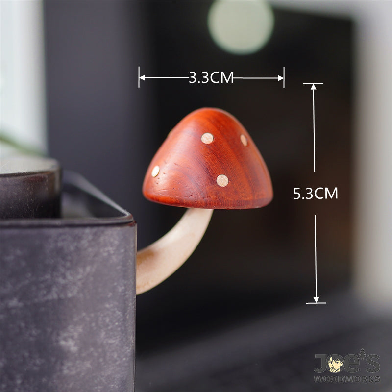 Wooden mushroom fridge magnet with height and width measurements shown