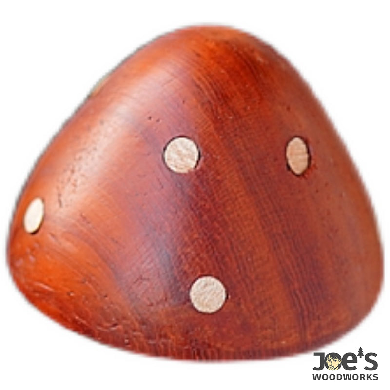 Close-up of red mushroom magnet highlighting wood grain and dot pattern
