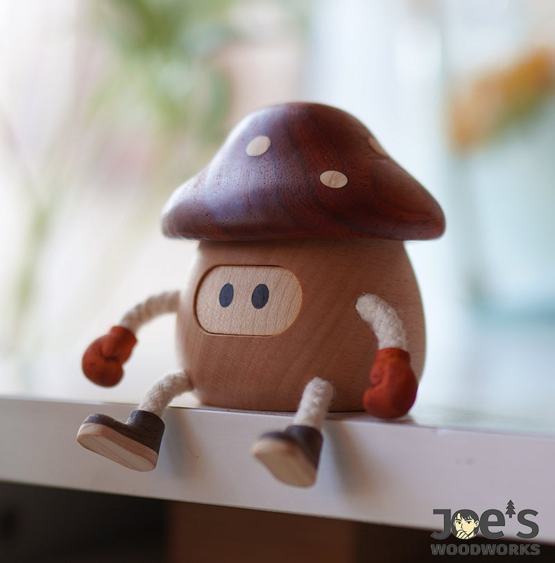 Mushroom-shaped wooden figure with oval eyes and dark brown top