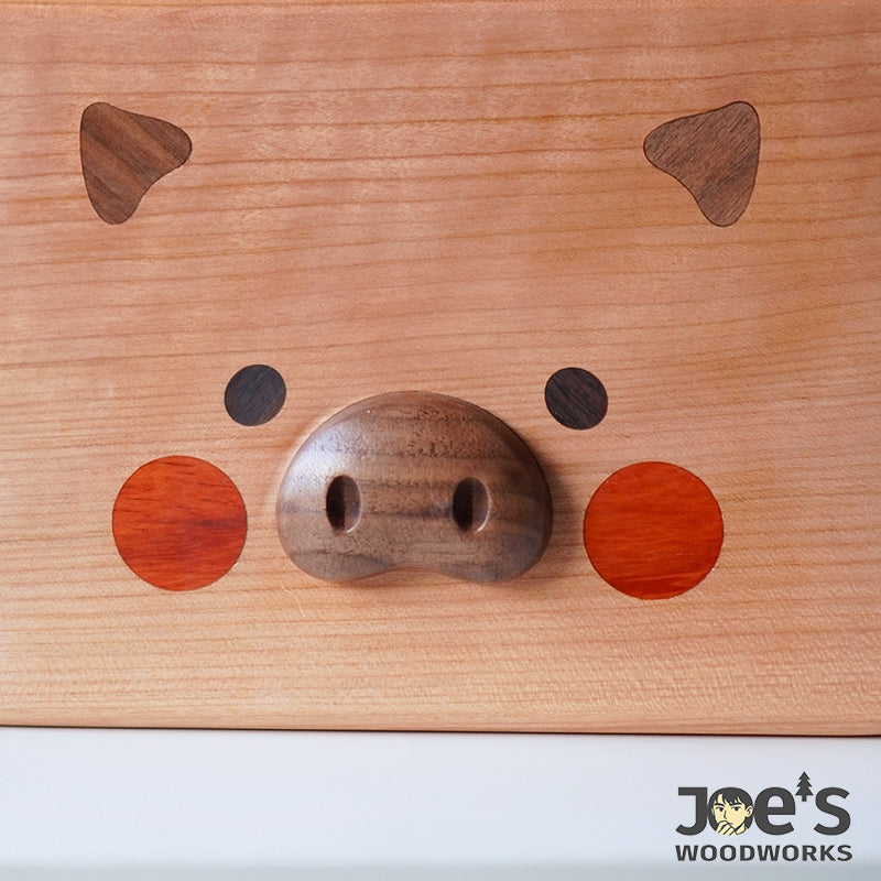 Close-up of piglet snout with walnut wood carving