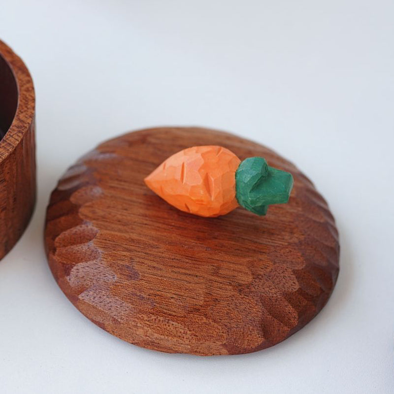 Close-up of hand-carved carrot lid on Pipimu wooden storage box, creative handmade detail