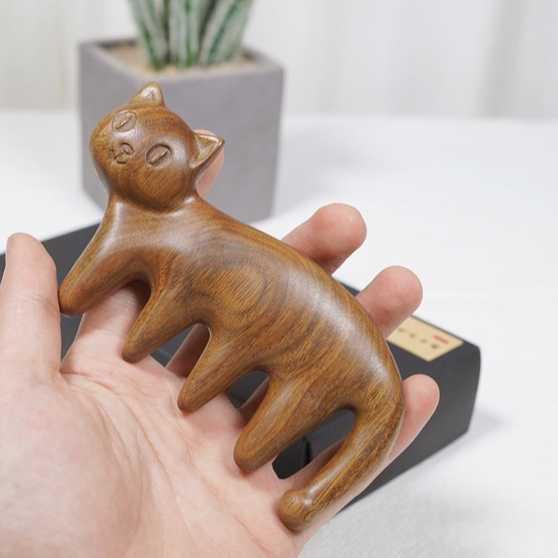 Pipimu Cat Mimi green sandalwood massage comb held in hand for scale