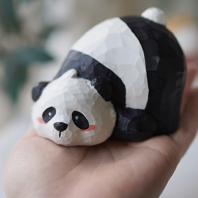 Hand holding Pobo the Panda wooden figurine, Pipimu Bear Family collection