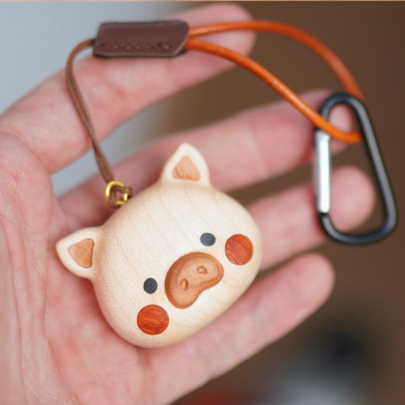 Poko wooden pig charm hanging on a bag strap, handmade by Pipimu