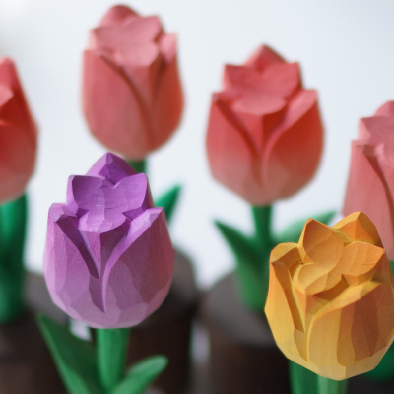 Close-up of hand-carved wooden tulip with detailed petals
