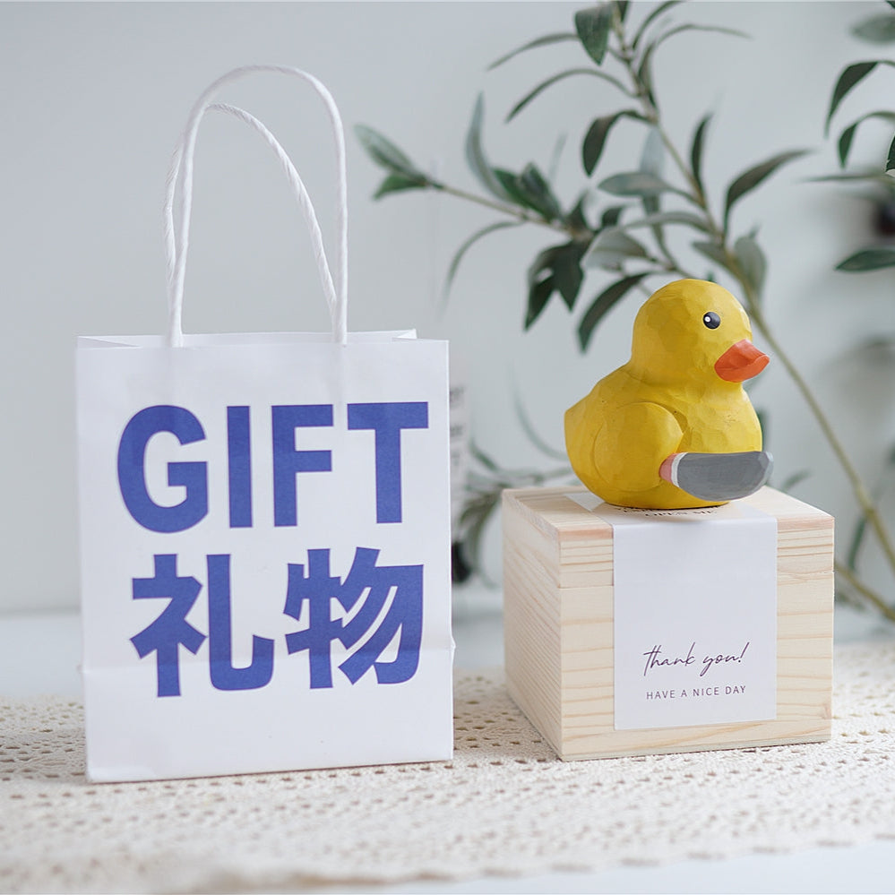 Wooden duck figurine on gift box – birthday present idea