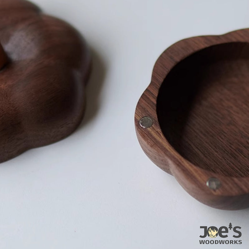 Detail of magnet and woodgrain texture inside the hand-carved wooden pumpkin box lid
