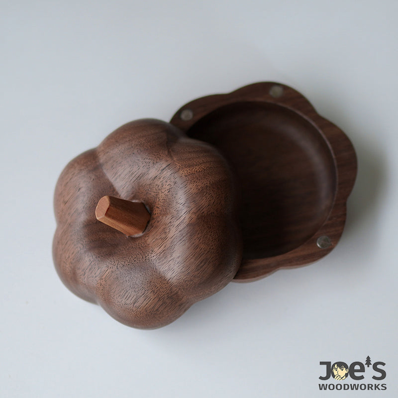 Pumpkin-shaped wood box with lid open and magnetic closure, ideal for storing small keepsakes