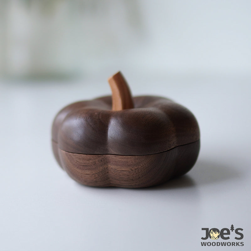 Closed view of the wooden pumpkin jewelry box, carved from walnut with soft curves