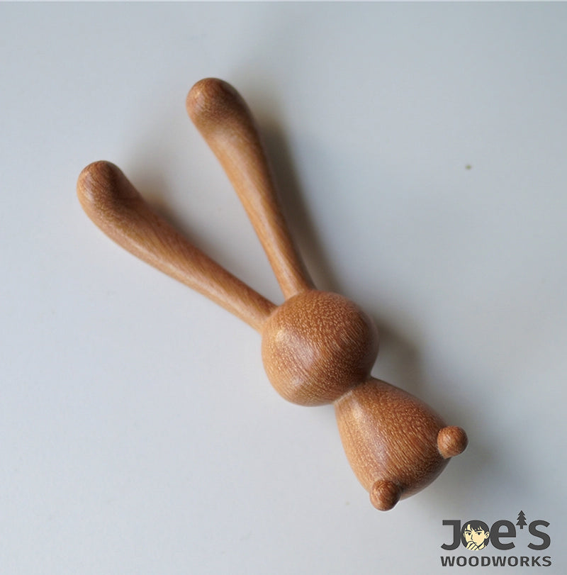 Flat lay view of the rabbit massage stick showing sleek wood finish