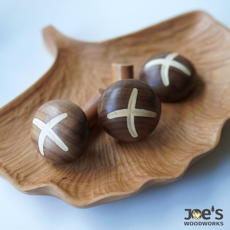 Natural wood blooming shiitake mushroom magnets resting in wooden leaf tray