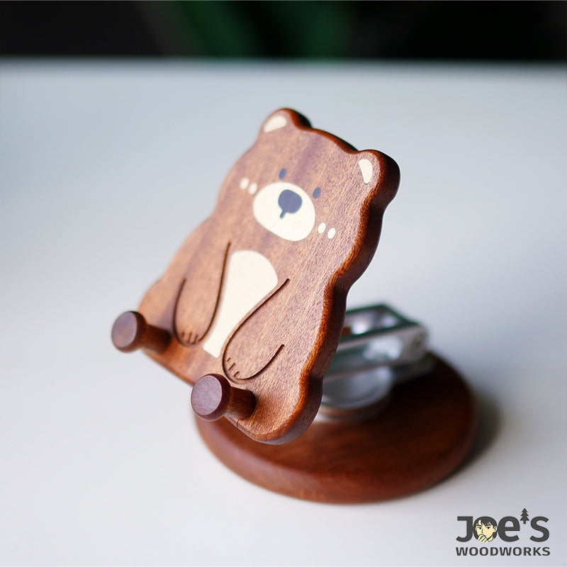 Side view of cute wooden bear phone stand showing carved depth and detail