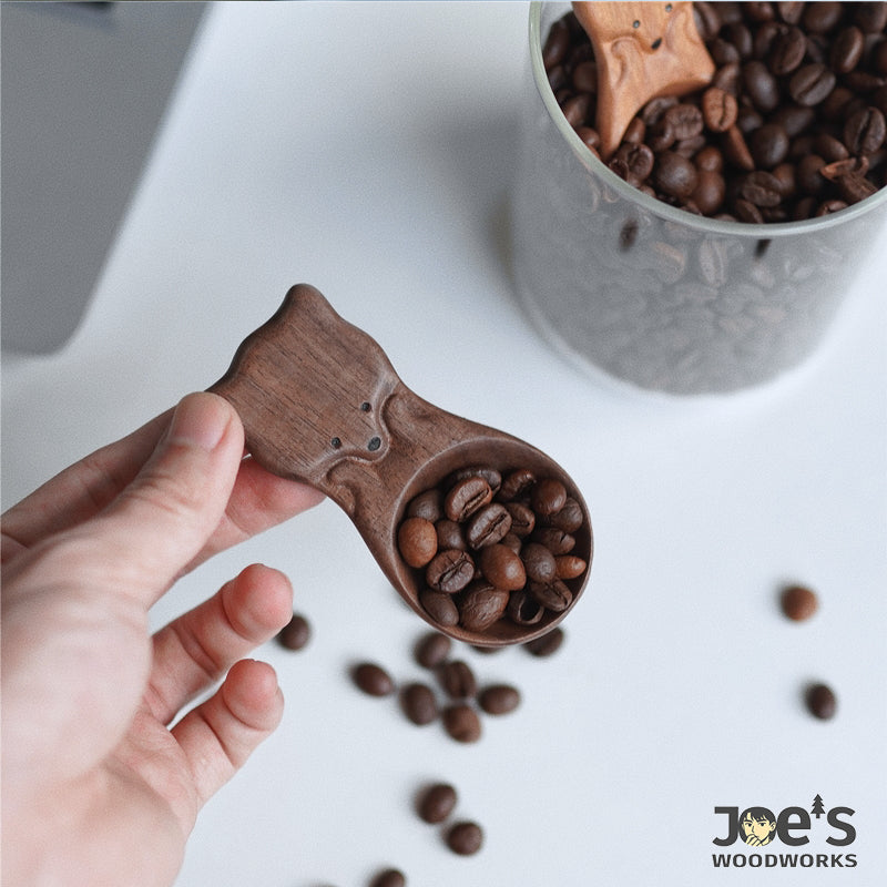 Fox-shaped walnut coffee scoop lifting roasted beans from jar – Joe’s Woodworks