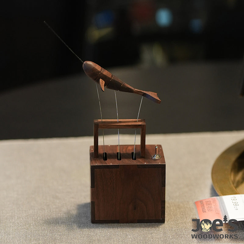Whale automaton decor displayed on a light fabric surface