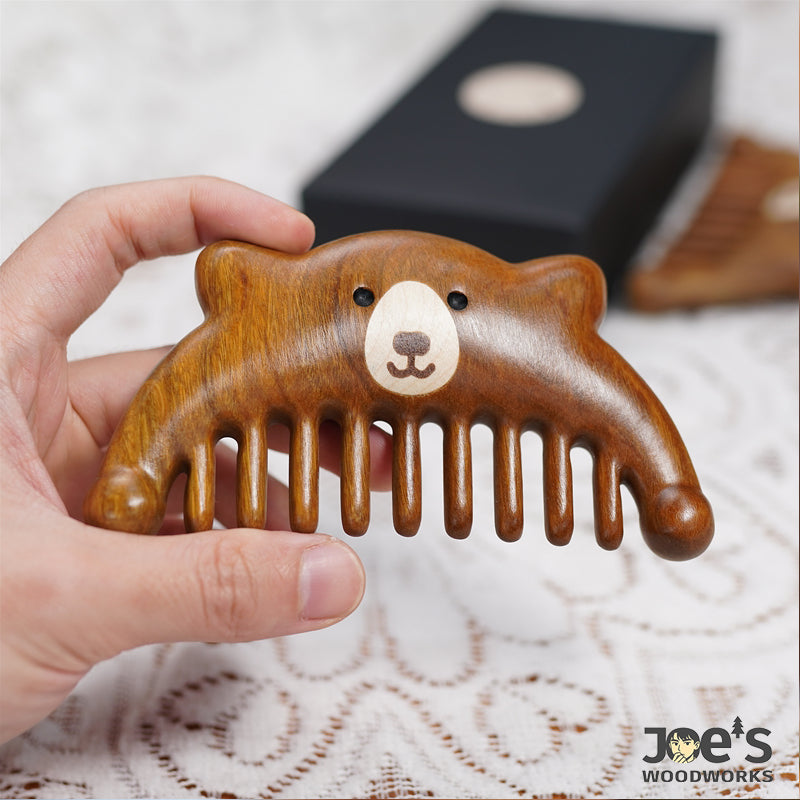 Front view of handcrafted bear wood comb with wide teeth