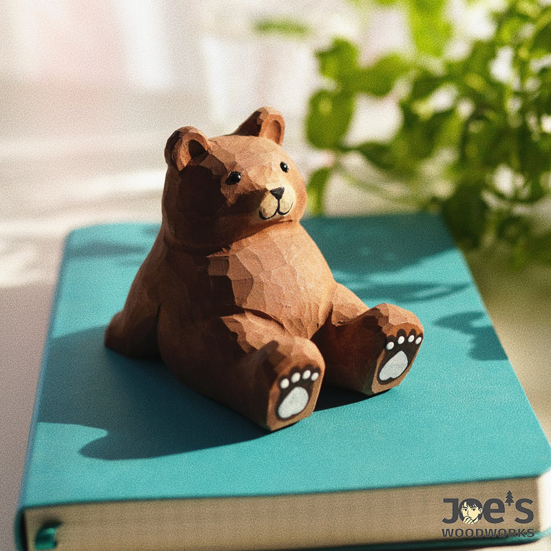 Cute wooden bear phone stand placed on a book, lovely as decor