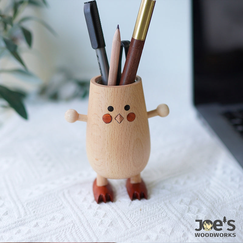 Wooden chick-shaped pencil holder used for desk organization and stationery