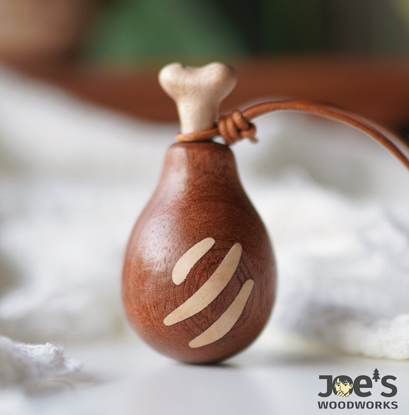Handcrafted wooden drumstick keychain with bone-shaped top and smooth carved surface - from Joe's Woodworks