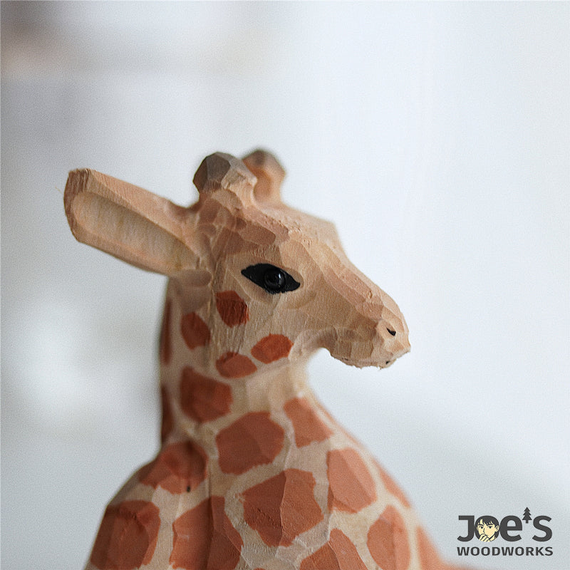 Close-up of hand-carved wooden giraffe face with detailed grain and paint texture