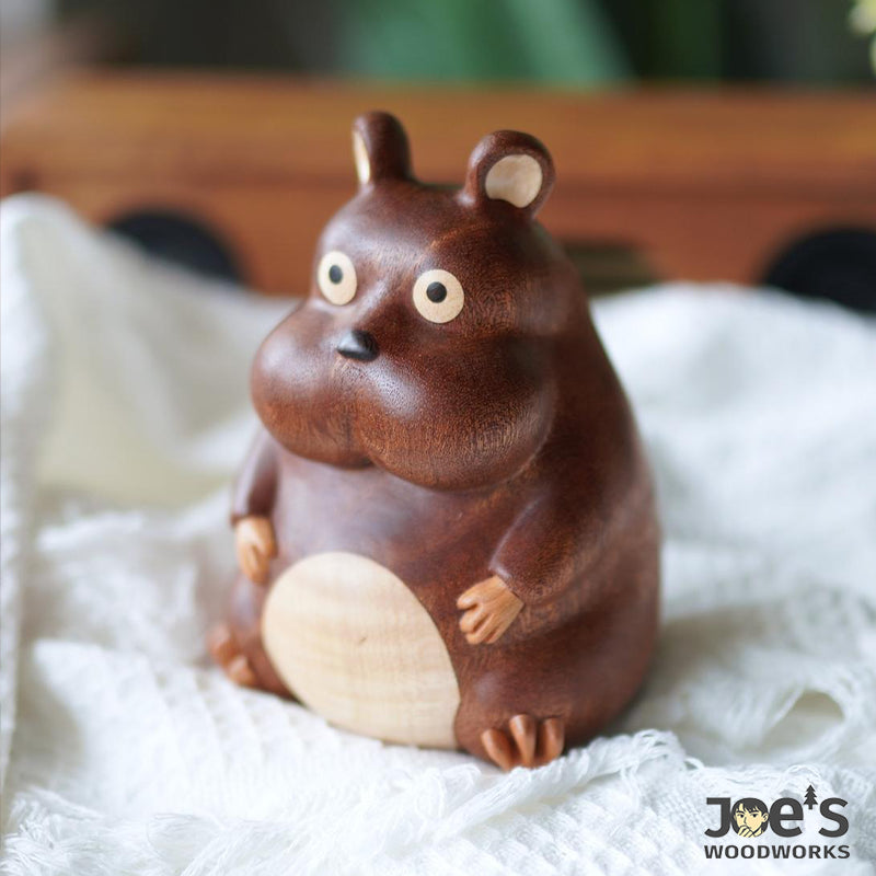 Whimsical wooden mouse figurine on soft cloth, great as playful home decor.