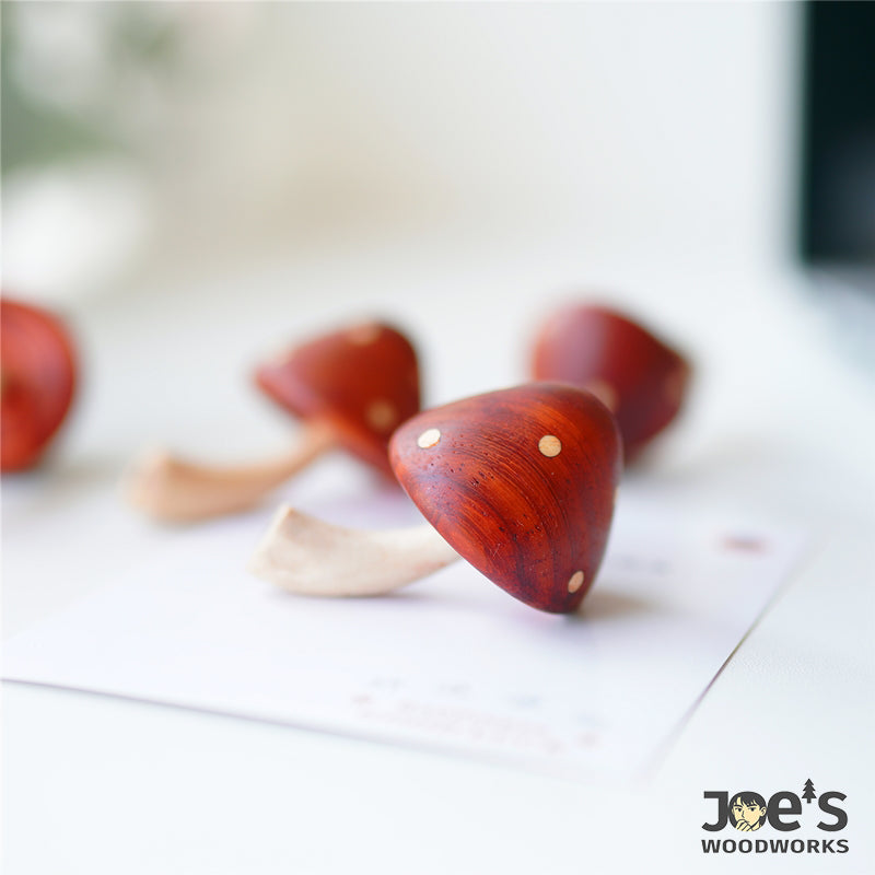 Set of handmade wooden mushroom magnets in whimsical red cap style for fridge decoration
