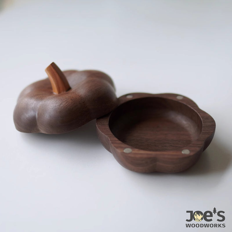 Elegant wooden jewelry box shaped like a pumpkin, crafted with smooth curves and grain