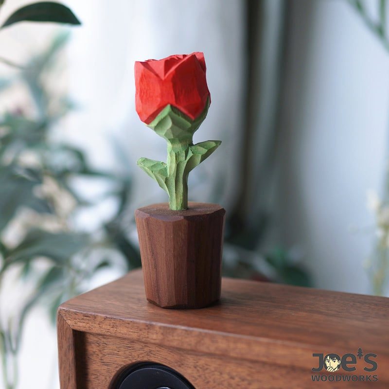 Mini wooden rose displayed on walnut speaker, elegant nature-inspired accent