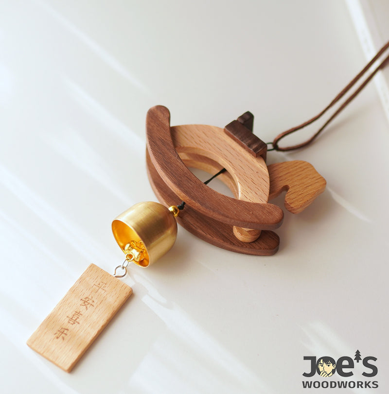 Detail of solid wood texture and bell accent on the handcrafted rocking horse wind chime